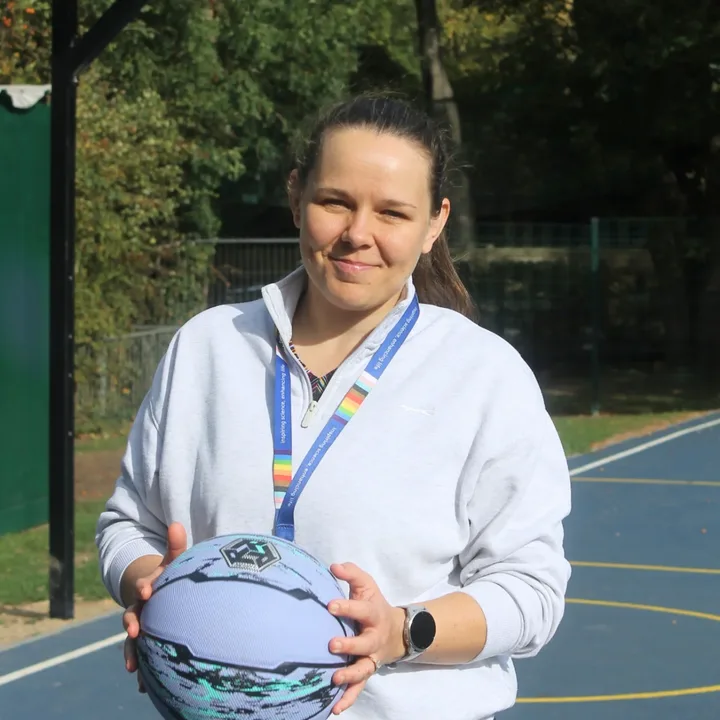 Rach smiling, holding a basketball